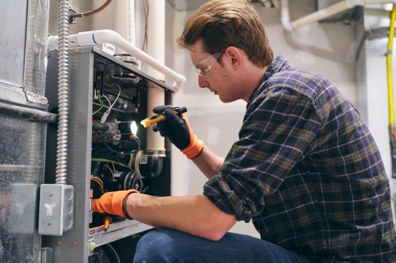Technician working on furnace.